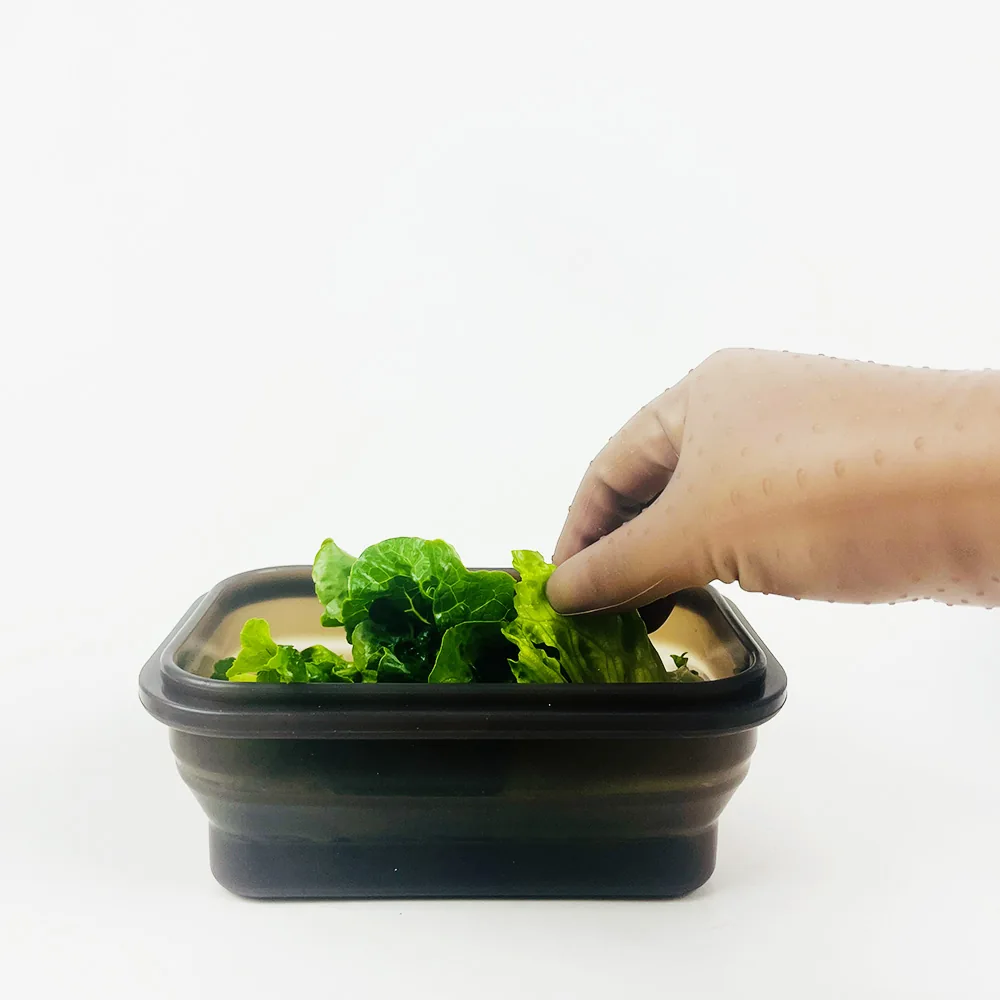 Black rectangular food container with vegetables and a fitted lid